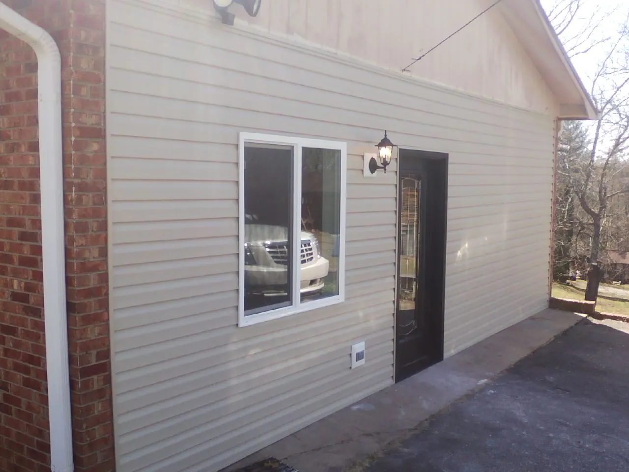 New vinyl siding and entry door on a room addition in Brush Prairie