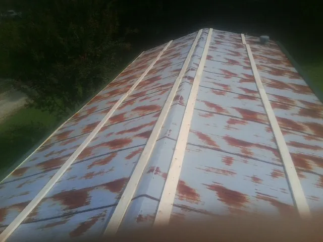 Rusted metal roof panels with new wood purlins before replacement — Storm Damage Roof Repair in Brush Prairie by Roofing Brothers